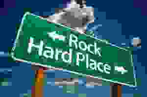 Rock and hard place road sign
