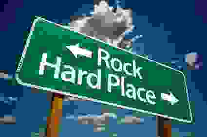 Rock and hard place road sign