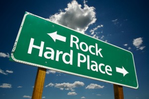 Rock and hard place road sign